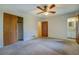 Comfortable bedroom featuring a ceiling fan, closet, and doorway to an adjacent bathroom at 1830 Francis Sw Rd, Conyers, GA 30094