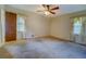 Bedroom with large window, tan carpet, and neutral walls at 1830 Francis Sw Rd, Conyers, GA 30094