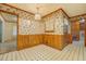 Dining area with decorative wallpaper, tiled floor, chandelier and wood-trimmed walls at 1830 Francis Sw Rd, Conyers, GA 30094