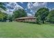 Charming brick home featuring well-maintained landscaping, a long porch, and classic shutters at 1830 Francis Sw Rd, Conyers, GA 30094