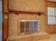 Living room brick fireplace with mantle, and a view of hardwood floors and window with blinds at 1830 Francis Sw Rd, Conyers, GA 30094