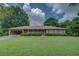 Charming single-story home with a lush green lawn and mature trees at 1830 Francis Sw Rd, Conyers, GA 30094