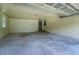 Spacious garage interior with paneled walls and a rolling door at 1830 Francis Sw Rd, Conyers, GA 30094