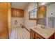 Laundry room with cabinets, sink and tile flooring at 1830 Francis Sw Rd, Conyers, GA 30094