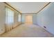 Open living room design with light colored carpet and natural wood trim throughout at 1830 Francis Sw Rd, Conyers, GA 30094