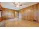 Living room with hardwood floors, wood paneled walls, and a brick fireplace at 1830 Francis Sw Rd, Conyers, GA 30094