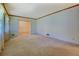 Spacious living room area, neutral colored carpet, and a view to additional room at 1830 Francis Sw Rd, Conyers, GA 30094
