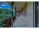 Inviting front porch with brick detailing, iron railing, and access to the front entry of the home at 1830 Francis Sw Rd, Conyers, GA 30094