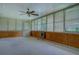 Cozy sunroom featuring multiple windows with blinds, a ceiling fan, and carpeting at 1830 Francis Sw Rd, Conyers, GA 30094