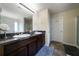 Bathroom featuring a double sink vanity, tile flooring and a large mirror at 303 Horizon Trce, Loganville, GA 30052