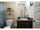 Neutral bathroom featuring a dark vanity, shower with curtain, and decorative shelving at 303 Horizon Trce, Loganville, GA 30052