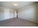 Bedroom featuring neutral carpet and walls, natural light from the window, and a closet at 303 Horizon Trce, Loganville, GA 30052