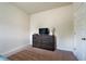 Bedroom showcasing a dresser with a television and a light-colored carpet at 303 Horizon Trce, Loganville, GA 30052