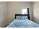Bright bedroom featuring a bed with patterned bedding and natural light from the window at 303 Horizon Trce, Loganville, GA 30052