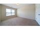 Bedroom featuring neutral carpet and walls, natural light from the window, and a closet at 303 Horizon Trce, Loganville, GA 30052