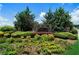 Stone community sign surrounded by lush landscaping and greenery creates a welcoming entrance at 303 Horizon Trce, Loganville, GA 30052