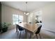 Bright dining room with a modern table, chairs, and contemporary light fixture at 303 Horizon Trce, Loganville, GA 30052