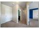 Hallway featuring neutral walls and carpets with multiple doorways to different rooms at 303 Horizon Trce, Loganville, GA 30052