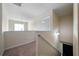 Upstairs landing featuring neutral colored walls and carpets with a staircase in view at 303 Horizon Trce, Loganville, GA 30052