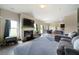 Open-concept living room featuring a fireplace, grey sofa, and view of the dining area at 303 Horizon Trce, Loganville, GA 30052