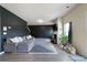 Living room featuring a comfortable grey sectional, black accent wall, and cozy fireplace at 303 Horizon Trce, Loganville, GA 30052
