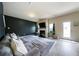 Bright living area featuring a grey sectional, fireplace, dark accent wall, and natural light at 303 Horizon Trce, Loganville, GA 30052
