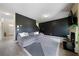 Inviting living room with a gray sectional sofa and a striking black accent wall at 303 Horizon Trce, Loganville, GA 30052
