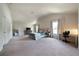 Bright main bedroom with carpet, TV and ample natural light at 303 Horizon Trce, Loganville, GA 30052