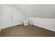 Attic space with a table, chairs and carpeted flooring, perfect for storage or a playroom at 4624 Stonehenge Dr, Atlanta, GA 30360