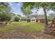 Spacious backyard featuring a well-maintained lawn, mature trees, play set and patio with seating at 4624 Stonehenge Dr, Atlanta, GA 30360