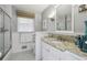 Bright bathroom featuring a vanity with granite countertop, tiled walls, and plenty of natural light at 4624 Stonehenge Dr, Atlanta, GA 30360