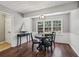 Cozy dining area boasts natural light and classic black chairs at 4624 Stonehenge Dr, Atlanta, GA 30360