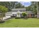 Charming two-story home featuring a well-manicured lawn, classic shutters, and an attached two car garage at 4624 Stonehenge Dr, Atlanta, GA 30360