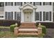 Stately front entrance with brick steps, manicured bushes, and a portico leading to double front doors at 4624 Stonehenge Dr, Atlanta, GA 30360