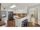 Well-maintained kitchen with black refrigerator and adjacent breakfast bar at 4624 Stonehenge Dr, Atlanta, GA 30360