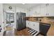 Functional kitchen with black appliances, tiled backsplash, and modern flooring at 4624 Stonehenge Dr, Atlanta, GA 30360