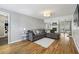 Cozy living room features a gray sofa, fireplace, and hardwood floors at 4624 Stonehenge Dr, Atlanta, GA 30360