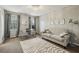 Bright living room featuring a sofa, glass desk, decorative rug, modern chandelier, and neutral tones at 4624 Stonehenge Dr, Atlanta, GA 30360