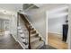 Carpeted staircase with wood banister leading to the upper level, complemented by tile and hardwood flooring at 4624 Stonehenge Dr, Atlanta, GA 30360