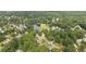 Aerial view of a quiet neighborhood with mature trees and a lake at 5286 Wild Indigo Nw Way, Acworth, GA 30102
