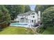Aerial view of a backyard featuring a pool, patio, and lush greenery surrounding the property at 5286 Wild Indigo Nw Way, Acworth, GA 30102