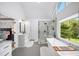 Bright bathroom featuring a soaking tub, glass-enclosed shower, and view of an adjacent bedroom at 5286 Wild Indigo Nw Way, Acworth, GA 30102