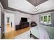 Spacious bedroom with a trey ceiling, hardwood floors, and a cozy sitting area near the window at 5286 Wild Indigo Nw Way, Acworth, GA 30102