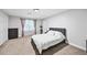 Bright bedroom featuring neutral colors, a large window, and double door closet at 5286 Wild Indigo Nw Way, Acworth, GA 30102