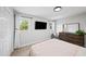 Relaxing bedroom with natural light, a mounted television and neutral walls at 5286 Wild Indigo Nw Way, Acworth, GA 30102