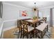 Elegant dining room features modern light fixtures, hardwood floors, and a comfortable seating arrangement at 5286 Wild Indigo Nw Way, Acworth, GA 30102