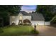 Beautiful white two-story home featuring a large front yard, three-car garage and mature landscaping at 5286 Wild Indigo Nw Way, Acworth, GA 30102