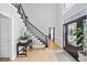 Bright foyer featuring hardwood floors, an elegant staircase, and a stylish front door at 5286 Wild Indigo Nw Way, Acworth, GA 30102