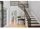 Light-filled foyer with hardwood floors and a staircase with iron railings at 5286 Wild Indigo Nw Way, Acworth, GA 30102