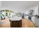 Bright kitchen with stainless appliances, a central island, white cabinets and a sunroom area with beautiful windows at 5286 Wild Indigo Nw Way, Acworth, GA 30102